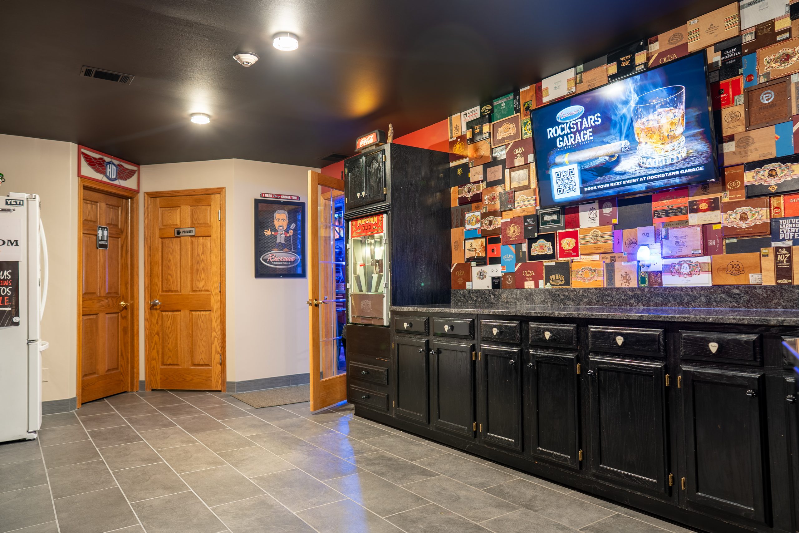 Kitchen wall covered in repurposed cigar box lids